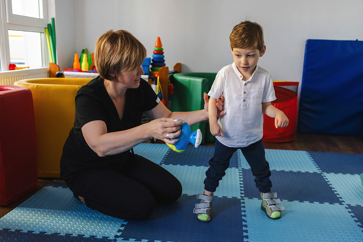 A Physical Therapist Teaching a young ABA Student